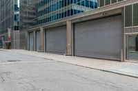 a person in a helmet on a city street near a large building with steel roller shutter doors