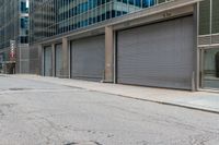 a person in a helmet on a city street near a large building with steel roller shutter doors