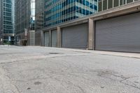 a person in a helmet on a city street near a large building with steel roller shutter doors