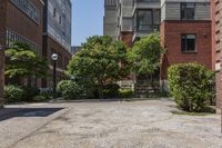 a sidewalk leading to some buildings and trees in a city street area by a park