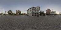 a fish eye lens view of a city street and a square building in the background