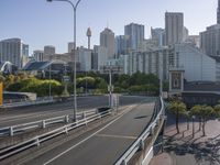 view across the city street on a sunny day, with an elevated highway in the foreground