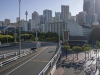 view across the city street on a sunny day, with an elevated highway in the foreground