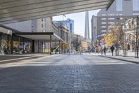 a walkway between the buildings that surround the area on this city street that is full of shops, people and bikes