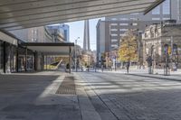 a walkway between the buildings that surround the area on this city street that is full of shops, people and bikes