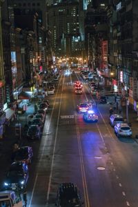 police cars are driving down a street in a city at night in the usa or europe