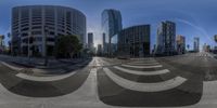 an image of a city street taken in a fisheye lens with the reflection of the building on the sidewalk