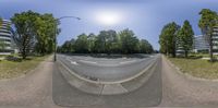 the 360 lens image shows a street with trees and a few buildings in the background