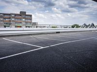 a street view of a bridge with the sky in the background and white lines on the pavement