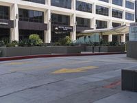 a city street is lined with a yellow line in front of a large building on the sidewalk