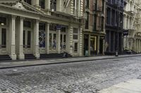 an older street with many old buildings and a bike in front of the building's doors