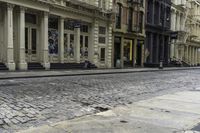 an older street with many old buildings and a bike in front of the building's doors