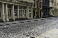 an older street with many old buildings and a bike in front of the building's doors