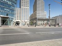 a city street with a building in the background and people walking past the building across the road