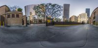 view through a small lens with city buildings behind it, and skateboarder in the process