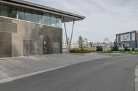 a view of an apartment complex next to a road with parking meters on the side