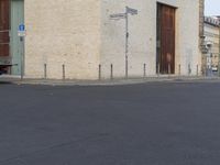 a person in red shirt riding a skateboard in street in city area with buildings and cars on pavement