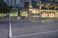 an intersection with cars driving through it at dusk during the day or evening in a city