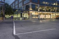 an intersection with cars driving through it at dusk during the day or evening in a city