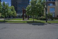 a tree lined street near a few high rise apartment buildings in the city of vancouver