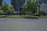 a tree lined street near a few high rise apartment buildings in the city of vancouver