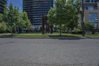 a tree lined street near a few high rise apartment buildings in the city of vancouver