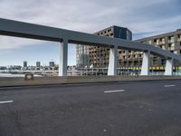 this is a view of a bridge over a river with an apartment building in the background