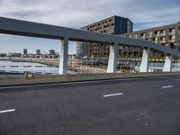 this is a view of a bridge over a river with an apartment building in the background