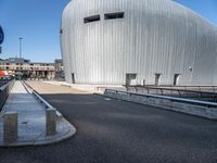 a view of the building next to a highway with no traffic or traffic cones around