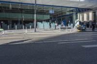 the sidewalk and sidewalk are covered with glass in this city area on a sunny day