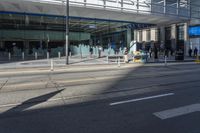 the sidewalk and sidewalk are covered with glass in this city area on a sunny day