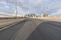 a view of an empty road through the front windshield of a car going over a bridge