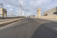 a view of an empty road through the front windshield of a car going over a bridge