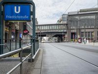 a street has a blue sign that says the station for friendstrape on it