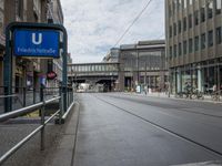 a street has a blue sign that says the station for friendstrape on it