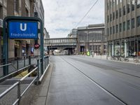 a street has a blue sign that says the station for friendstrape on it