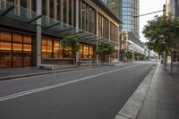 there is a road leading to a building and a bench on the side of it