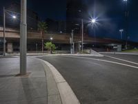 streetlights shine brightly on a deserted and empty street at night in the city streets