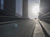 the sun is setting on a very big city skyline in the afternoon sun reflects off the glass windows and sidewalk