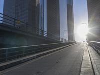 the sun is setting on a very big city skyline in the afternoon sun reflects off the glass windows and sidewalk