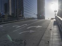 the sun is setting on a very big city skyline in the afternoon sun reflects off the glass windows and sidewalk