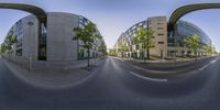 a view of two buildings on a street from a fisheye lens with no people looking at them