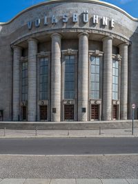 an entrance of a building with large columns and doors that spell out the word voltege