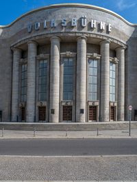 an entrance of a building with large columns and doors that spell out the word voltege