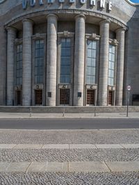 an entrance of a building with large columns and doors that spell out the word voltege