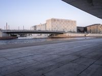 a wide river near a large building in a city area of a large city with a bridge