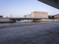 a wide river near a large building in a city area of a large city with a bridge