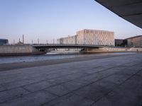 a wide river near a large building in a city area of a large city with a bridge