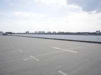 a boat is parked in an empty parking lot near an air port on the water