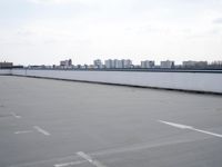 a boat is parked in an empty parking lot near an air port on the water